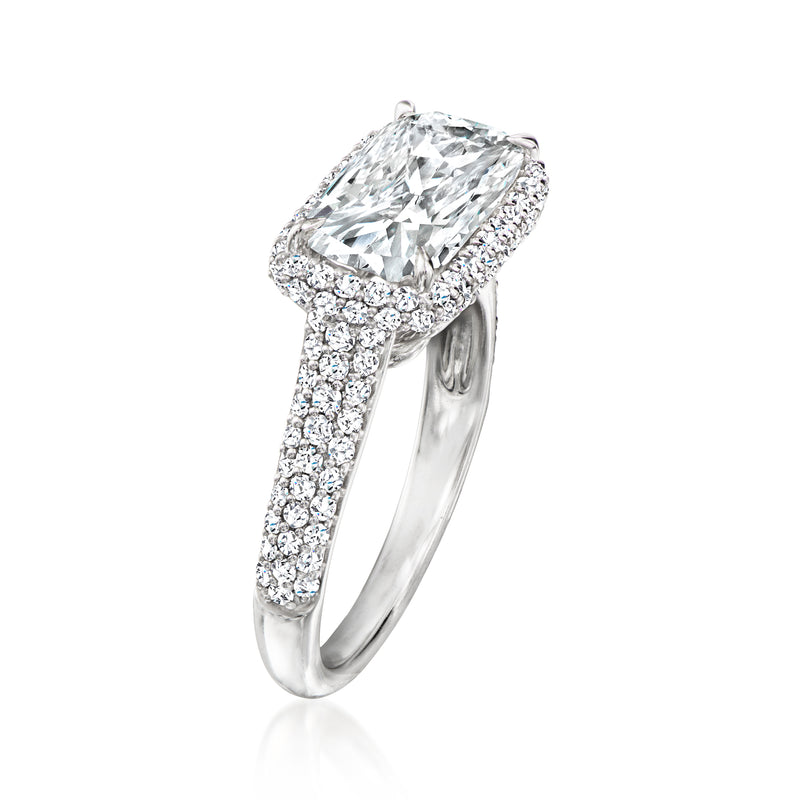Platinum diamond ring with oval center stone and sparkling pave band, side view