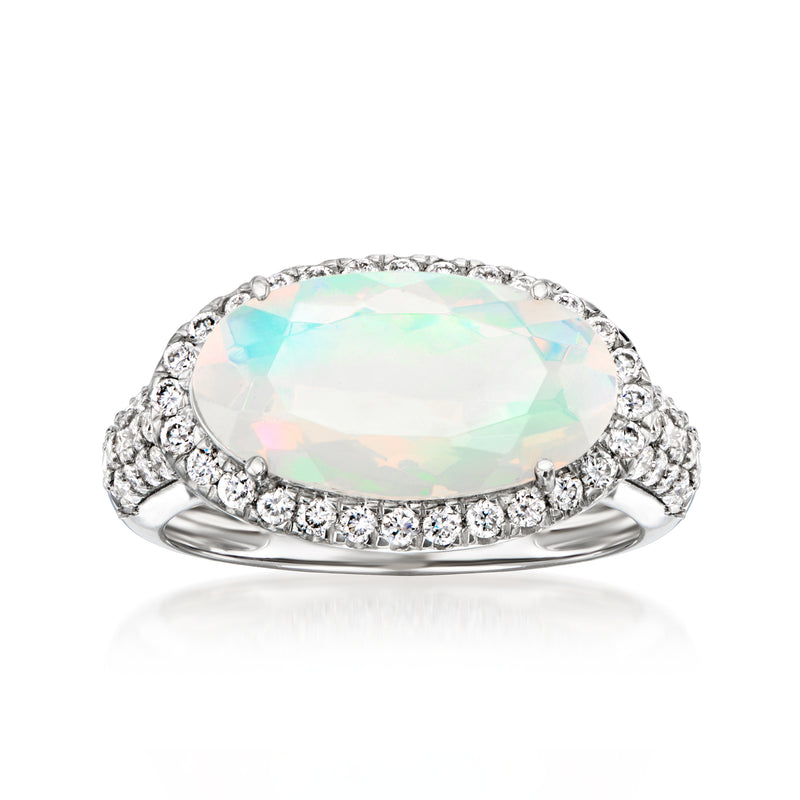 Platinum ring with oval opal-like center and diamond halo band