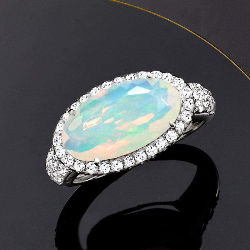 Opal and lab-grown diamond ring in platinum with oval opal and pavé diamond halo