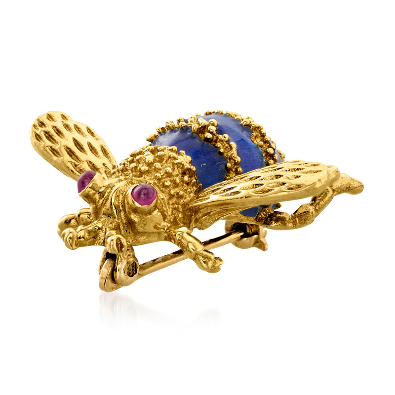 Gold bee pin with blue enamel segments, ruby-red stones, wing detail angle