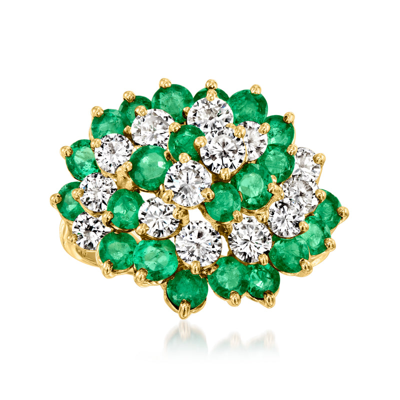 18kt yellow gold swirl ring with emerald green stones and round diamonds