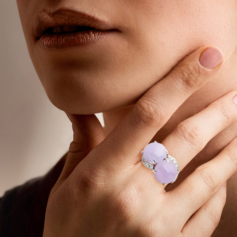 Lavender oval gemstone ring on finger in 14kt white gold with diamond accents