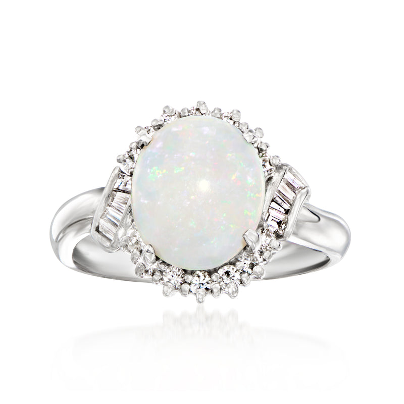 Vintage platinum opal oval cabochon ring with diamond halo and baguette side accents