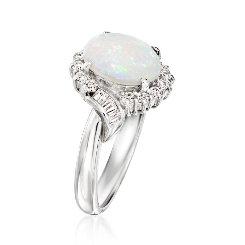 Platinum oval opal cabochon ring with raised diamond halo and baguette side details