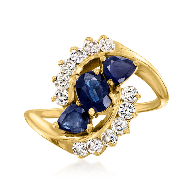 14kt yellow gold swirl ring with deep blue sapphire center and diamond halo
