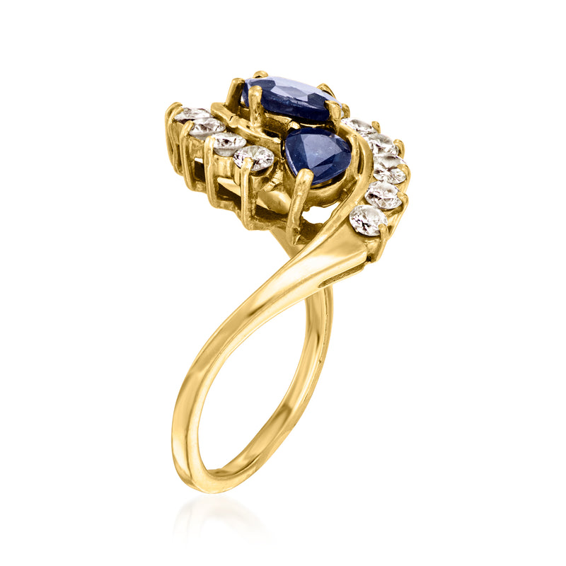 14kt yellow gold ring with blue sapphire and round diamonds in a swirl setting