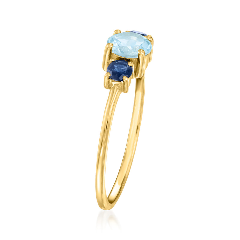 Yellow gold ring view with oval sky blue topaz center and blue sapphire side stones