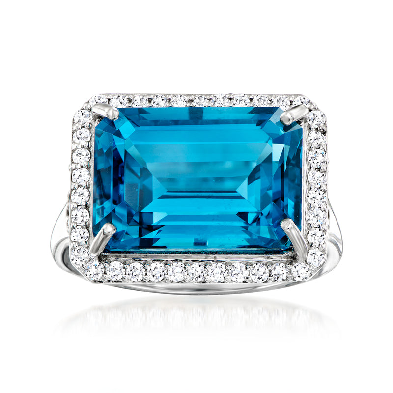 Platinum ring with east-west emerald-cut blue topaz and diamond halo