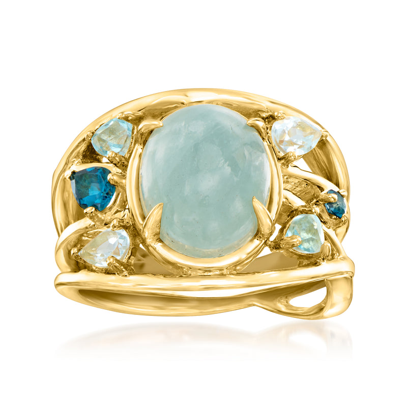 Gold-tone ring with oval milky aquamarine center and blue gemstone side accents
