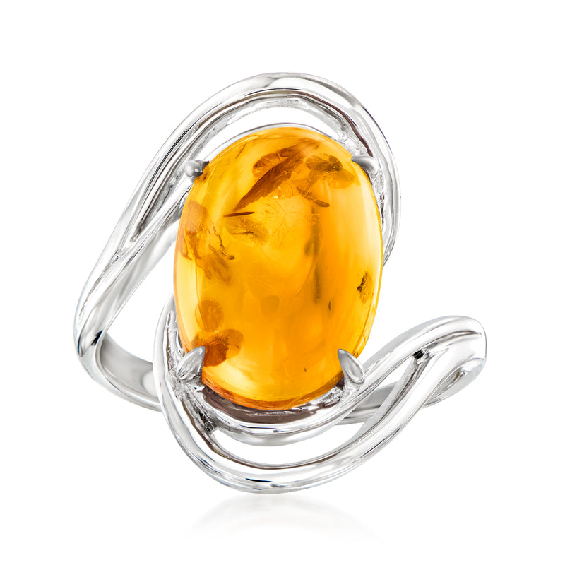 Sterling silver ring with oval amber cabochon gemstone in swirling setting