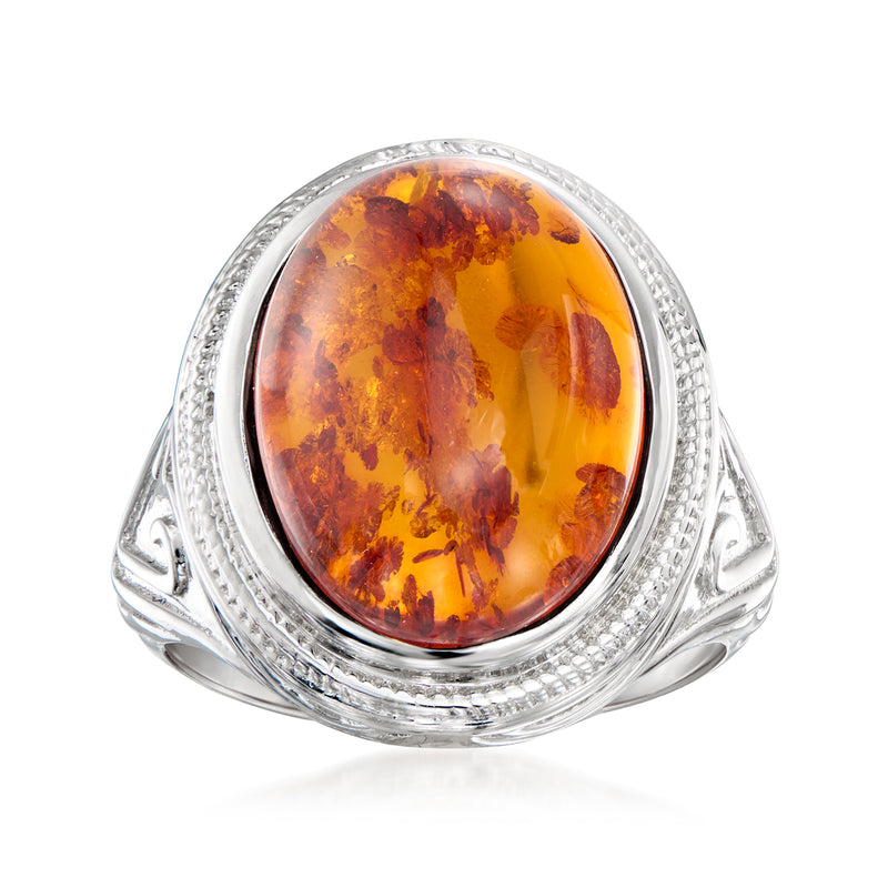 Sterling silver amber oval ring with ornate bezel and facet-like border