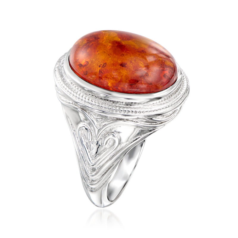 Sterling silver amber cabochon oval ring with textured surround and leaflike details