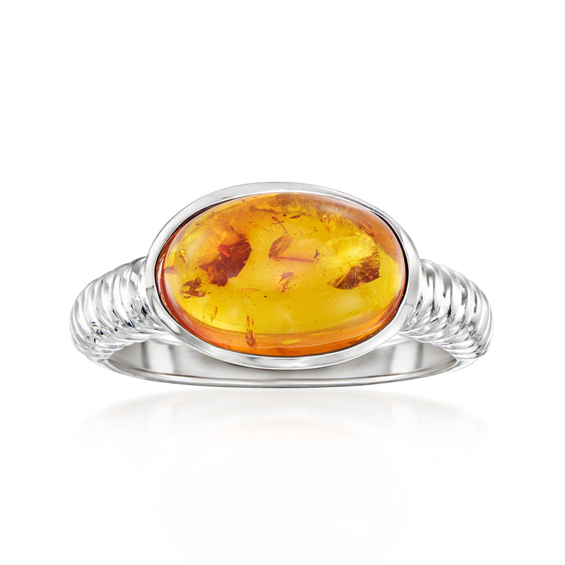 Sterling silver amber ring with oval amber cabochon center and twisted band
