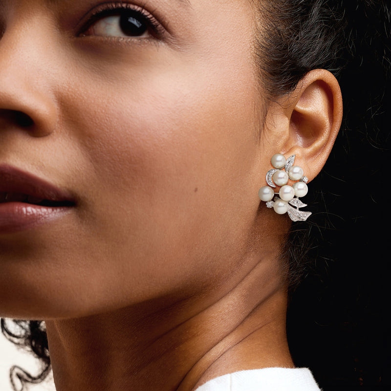 Pearl and diamond cluster earrings worn, multiple white pearls with sparkling accents
