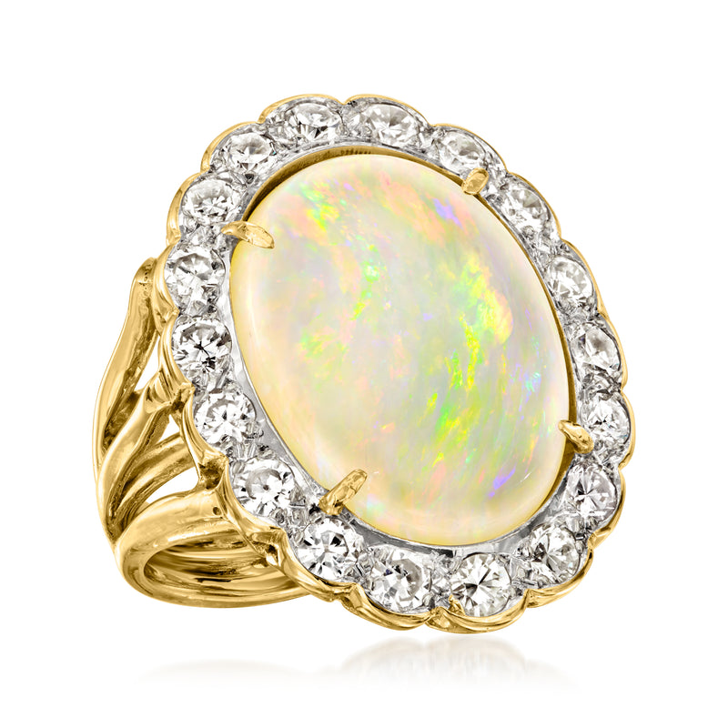 Yellow gold oval opal ring with diamond halo and curved gallery sides