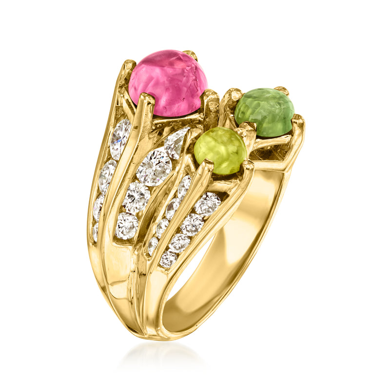 18kt yellow gold bypass ring with pink center, green stones, and diamond side rows