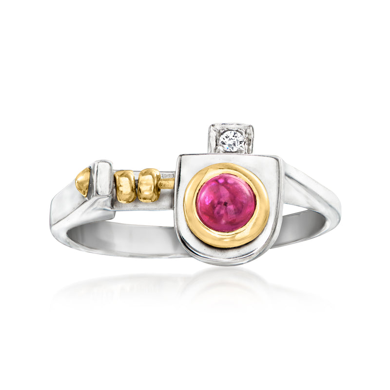 Vintage platinum ruby ring with yellow-gold bezel, pink center stone, and single diamond