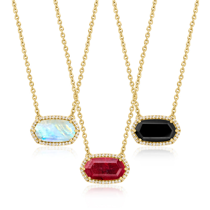 Gold-tone three-stone necklace with oval opal, black, and red gemstones and crystal halos