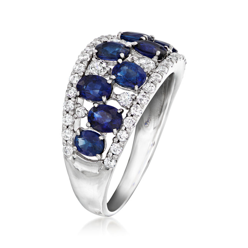 Platinum ring with raised oval blue sapphire cluster and surrounding round white diamonds