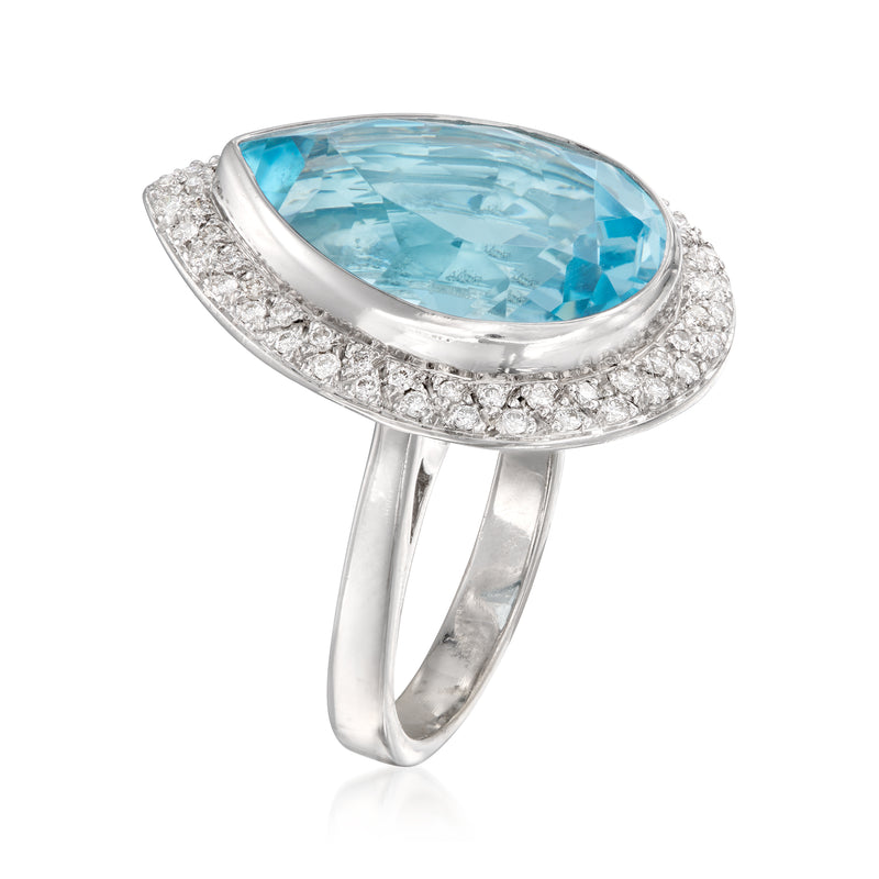 Vintage 18kt white gold cocktail ring with oval blue topaz and diamond halo