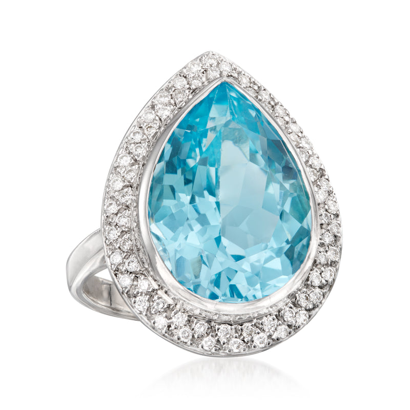 Vintage cocktail ring with pear-cut blue topaz center and diamond cluster halo, white gold