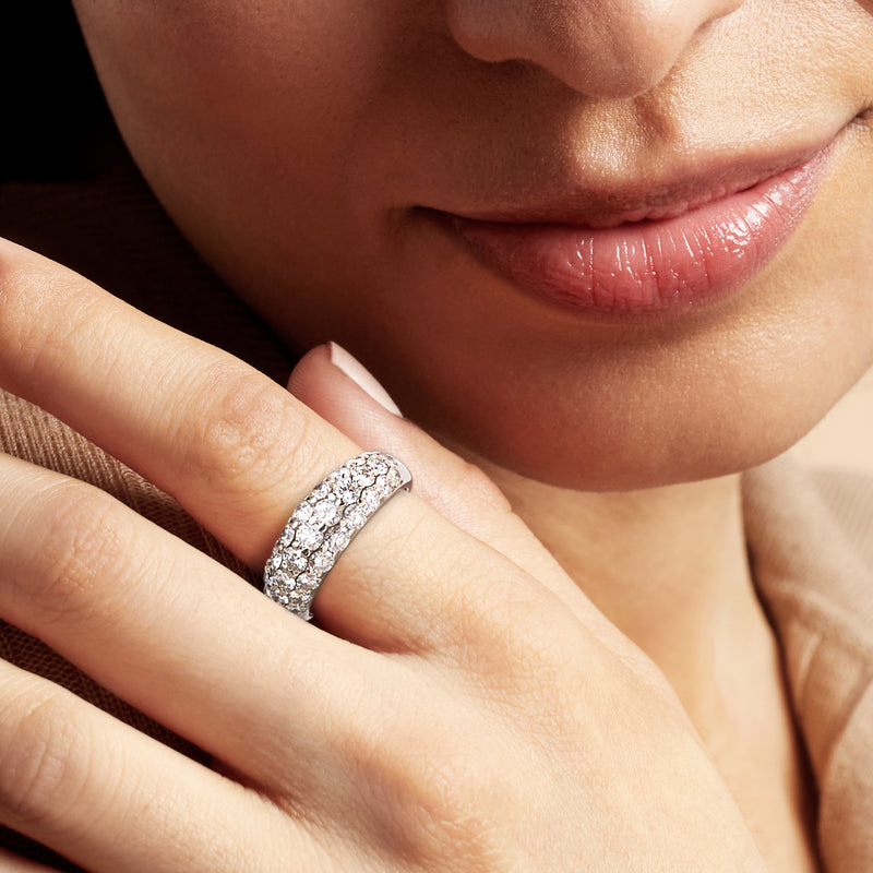 Vintage platinum three-row diamond ring on a hand