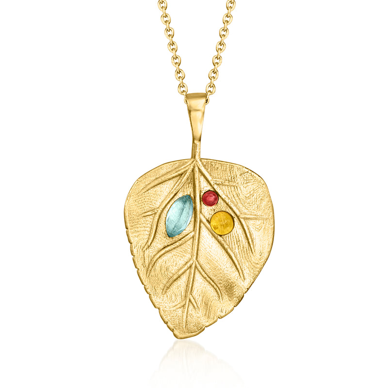 Gold leaf pendant with blue, red, and yellow gemstone accents on a chain