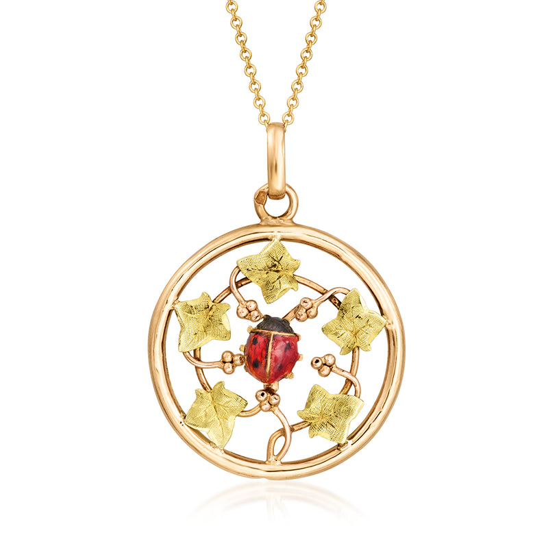Gold-tone pendant necklace with red ladybug enamel in round leafy frame