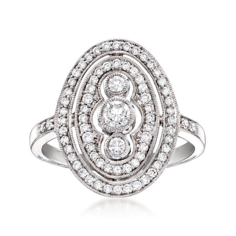 Diamond oval ring in 14kt white gold with halo and three-stone center
