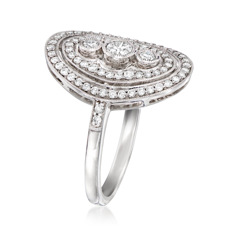 Vintage oval diamond ring in 14kt white gold with pavé halo