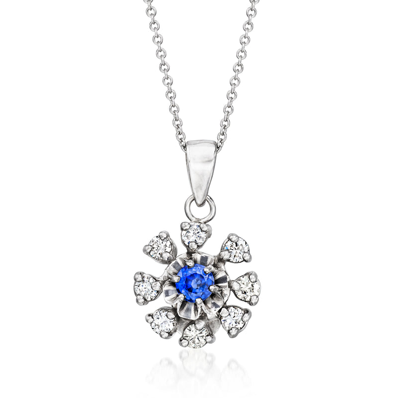 White gold pendant necklace with blue sapphire center and round diamond cluster