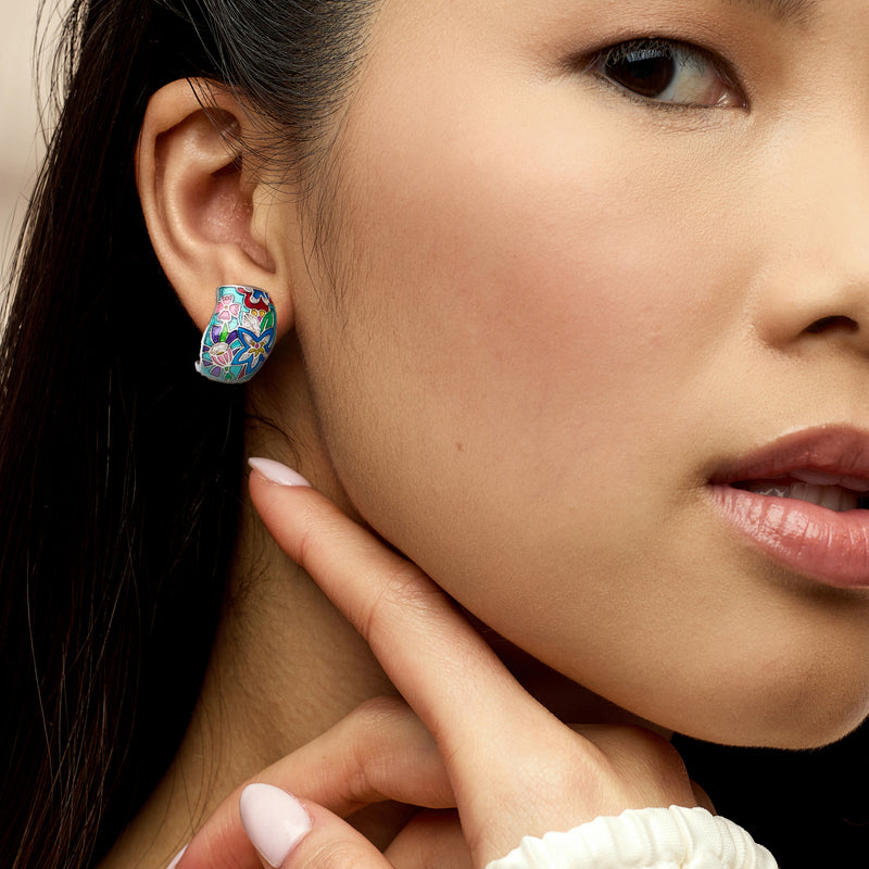 Floral enamel hoop earrings in multicolor with CZ details on model, sterling silver