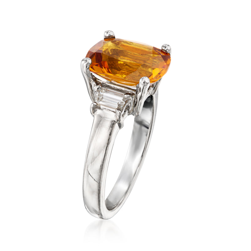 Platinum ring with oval orange citrine in prong setting and baguette diamond sides
