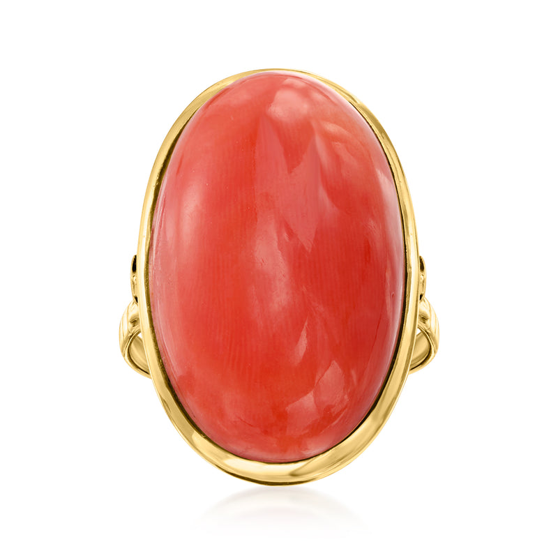Oval coral cabochon ring in 18kt yellow gold with split shoulders