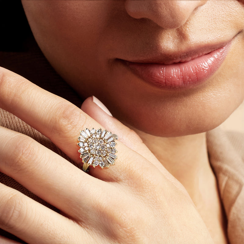 Cluster diamond ring on finger with round diamonds and pave halo, yellow gold band