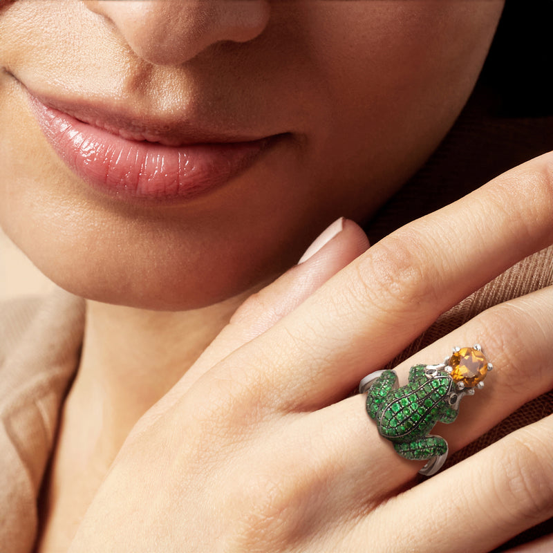 Vintage frog ring with green stones and citrine on a hand