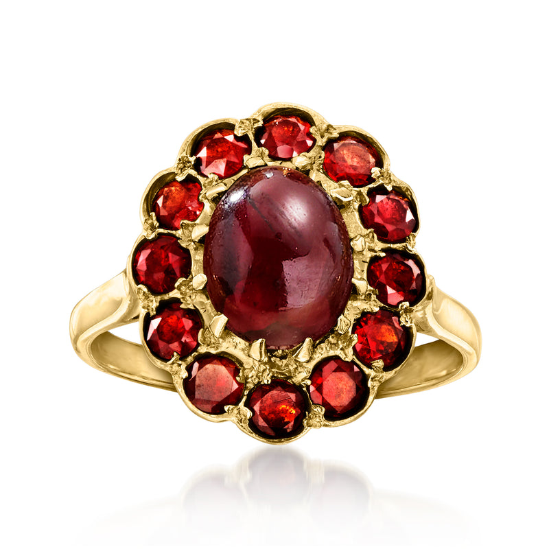 Vintage 9kt yellow gold garnet ring with oval dark red center and red stone halo