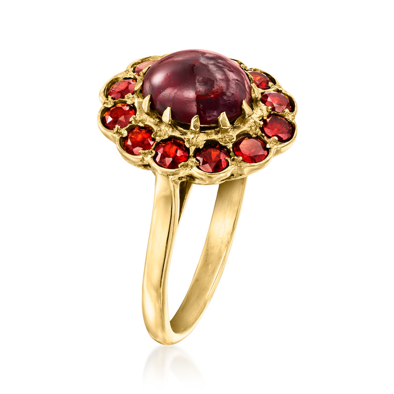 Vintage 9kt yellow gold garnet ring with oval dark red cabochon and red stone halo