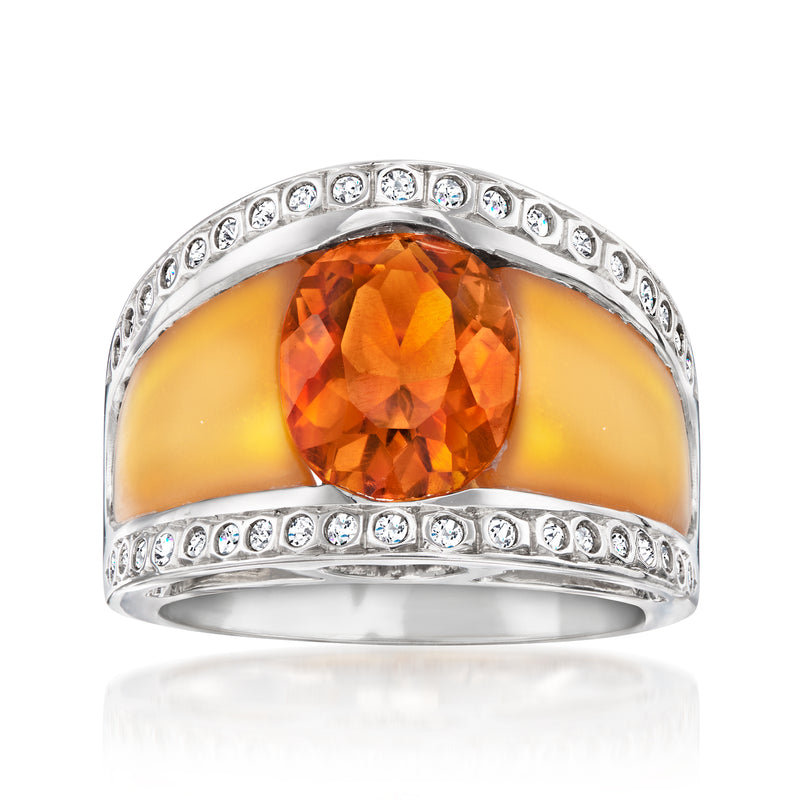 White gold ring with round orange gemstone, amber center, and small diamond accents