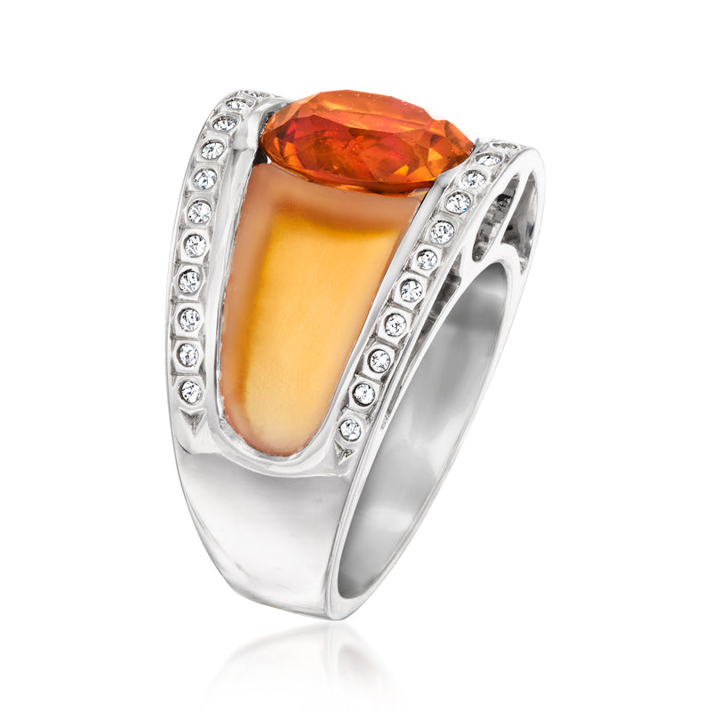 White gold ring with oval orange gemstone and diamond-lined side borders