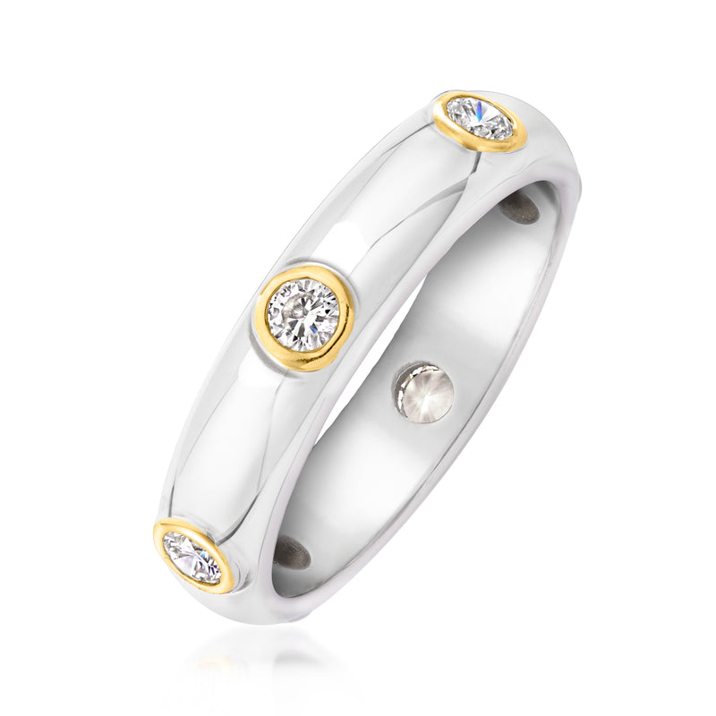 Sterling silver diamond ring with gold bezel settings and three round stones across the band