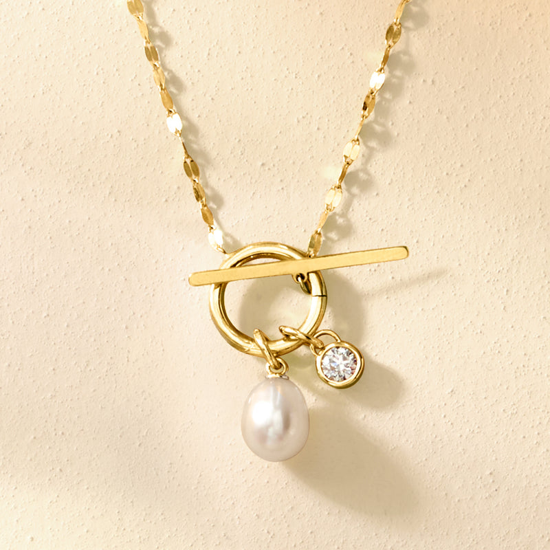 Yellow gold charm pendant with round diamond, bar accent, and pearl drop