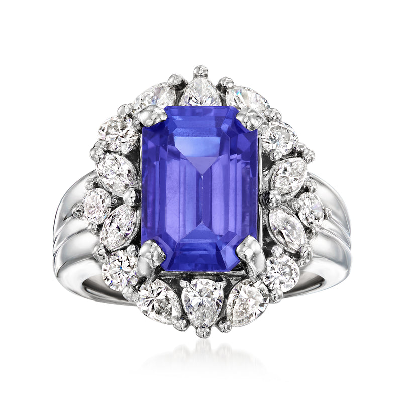 Platinum vintage ring with emerald-cut tanzanite center and diamond halo