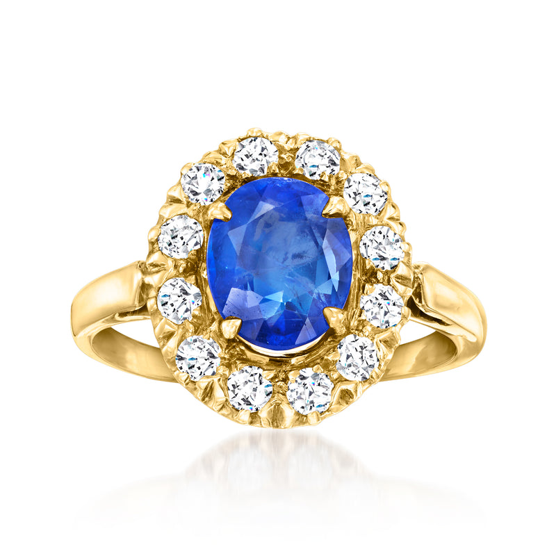Vintage yellow gold sapphire and diamond ring with oval blue center and round halo