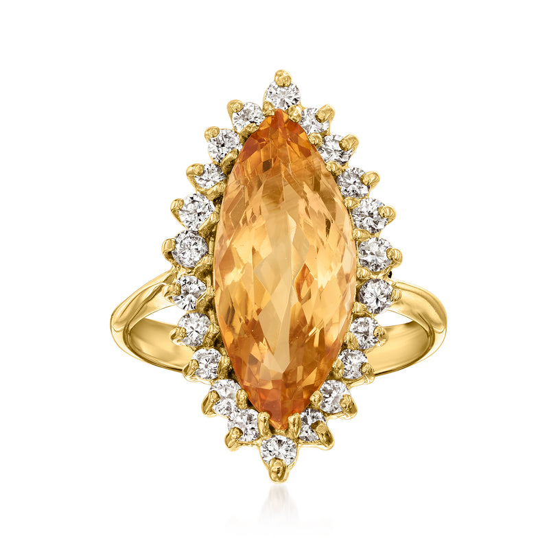 Yellow gold ring with oval orange topaz center and diamond halo cluster