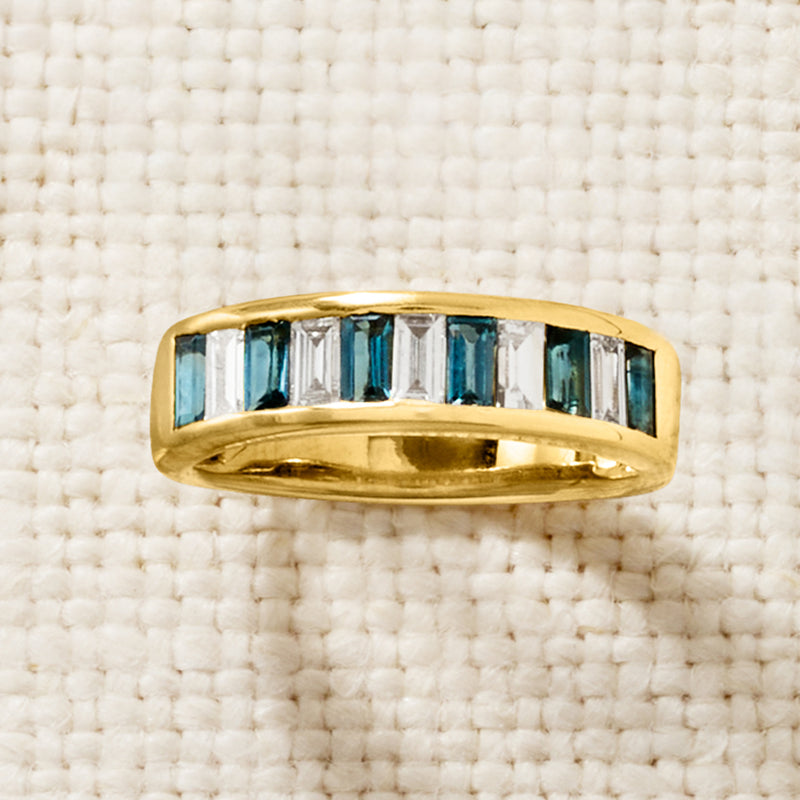 Gold band ring with blue topaz and clear diamond accents in rectangular channel