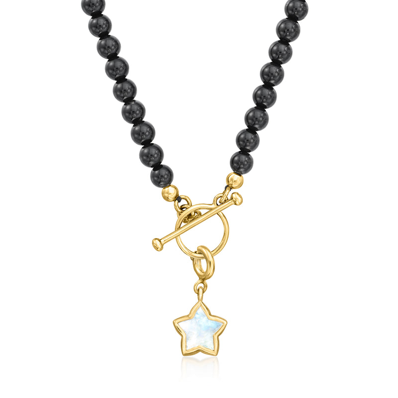 Gold-tone star charm with mother-of-pearl center hanging from black bead strand