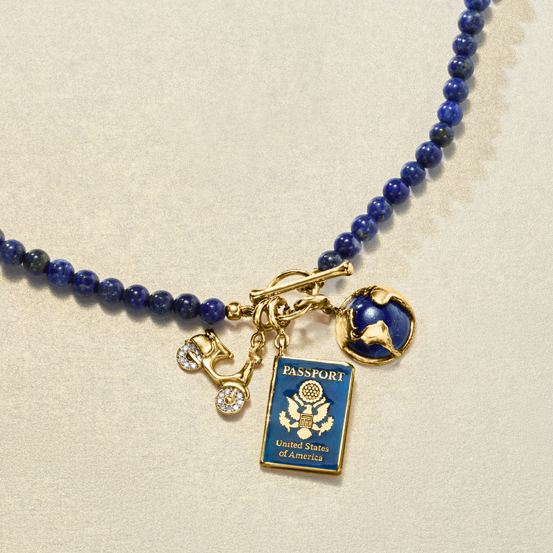 Gold scooter charm with diamond-accented wheels on a blue bead necklace chain