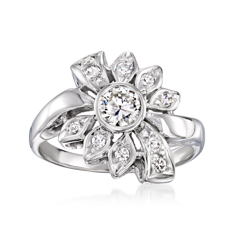 Vintage white gold diamond ring with round center stone and floral petal cluster