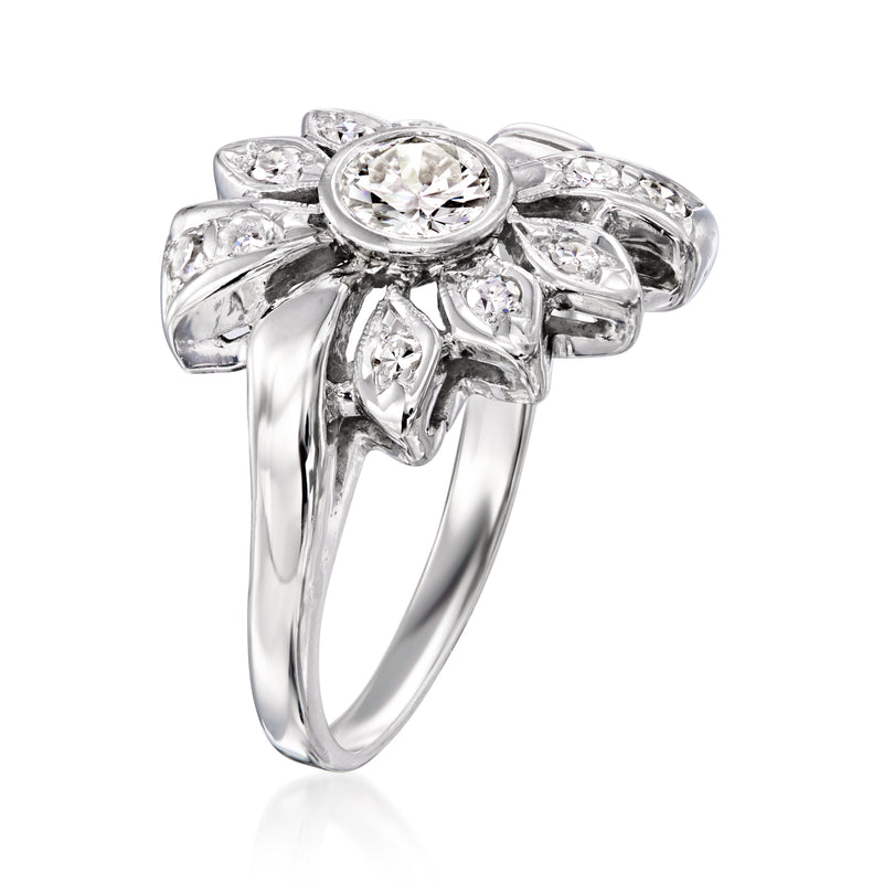 White gold diamond flower ring with round center stone and curved petal settings